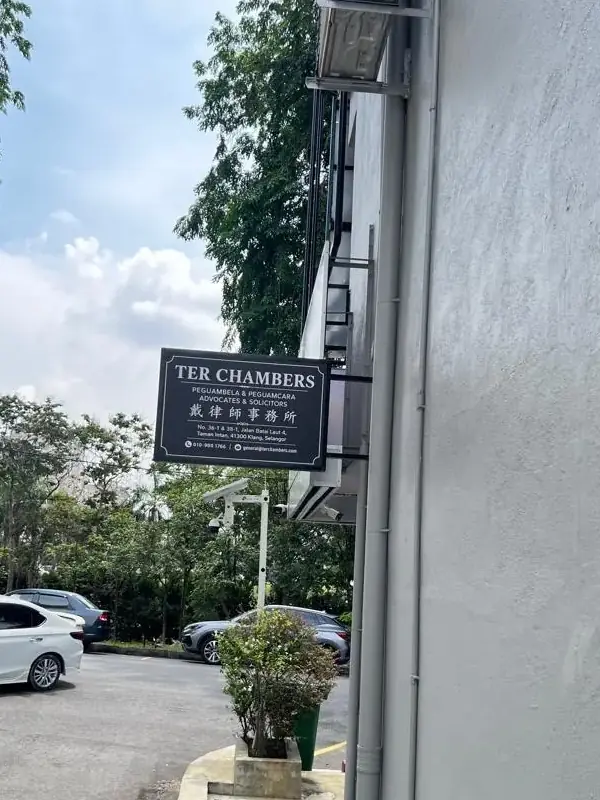 The firm's projecting blade sign above the pavement